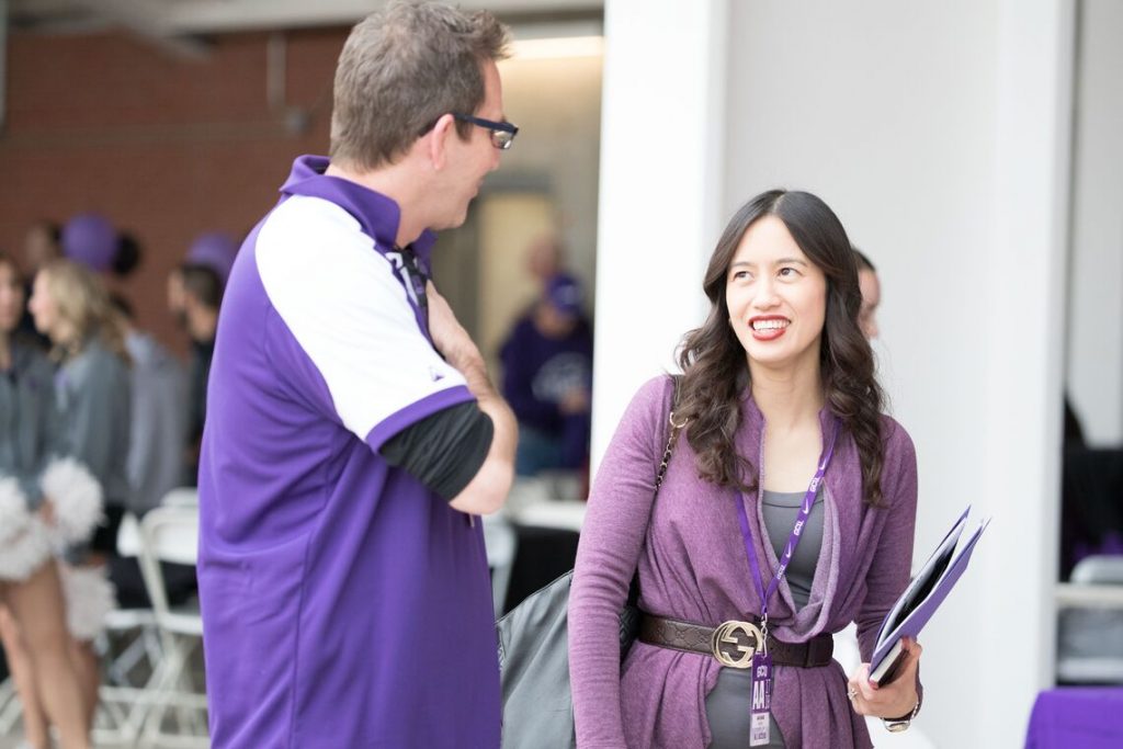 Two people talking at an event