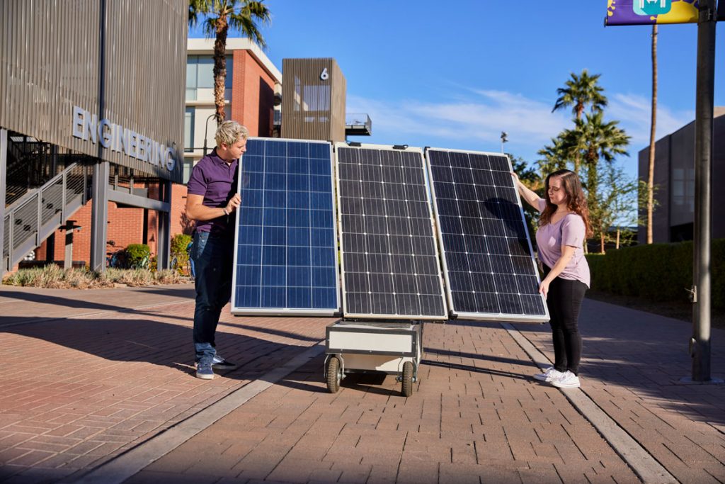 Students setting up solar panels 