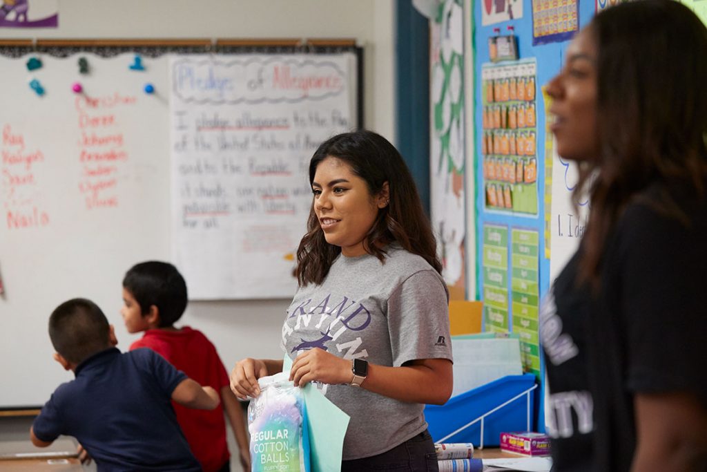 Young teacher standing at front of classroom